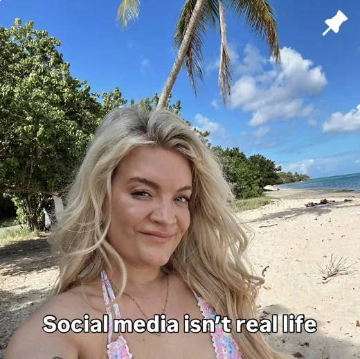 Hannah smiling on a beach
